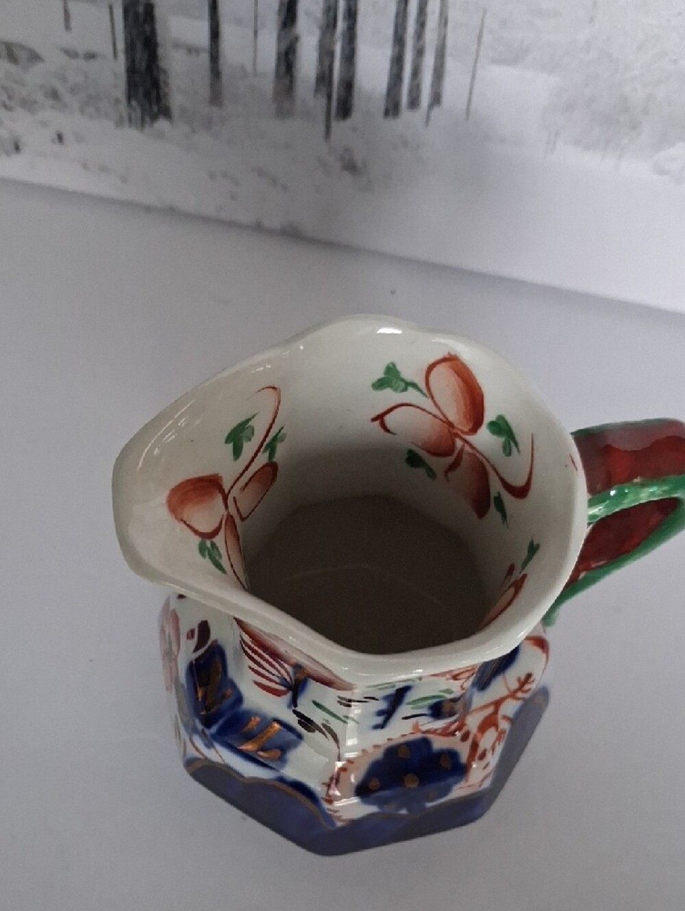 Hand-Painted Ceramic Pitcher with Blue Floral Motif and Green Handle - Picture 3 of 4